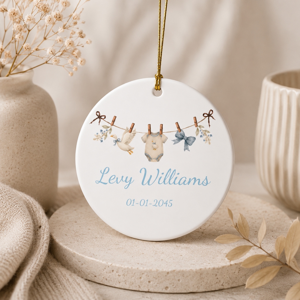 Close-up of baby boy duck clothesline ornament with gold string — personalised ceramic gift for newborn