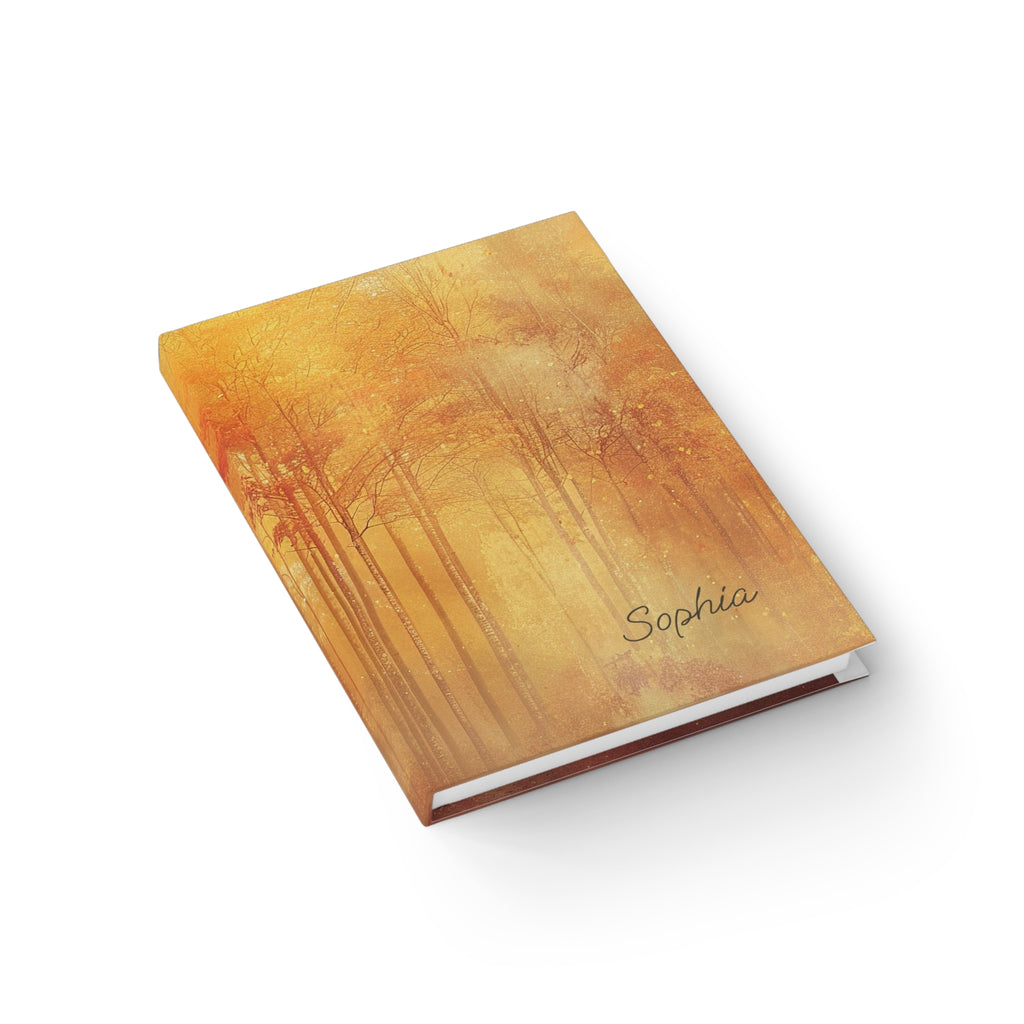 Autumn forest journal lifestyle shot — personalised hardcover notebook open flat with golden forest cover